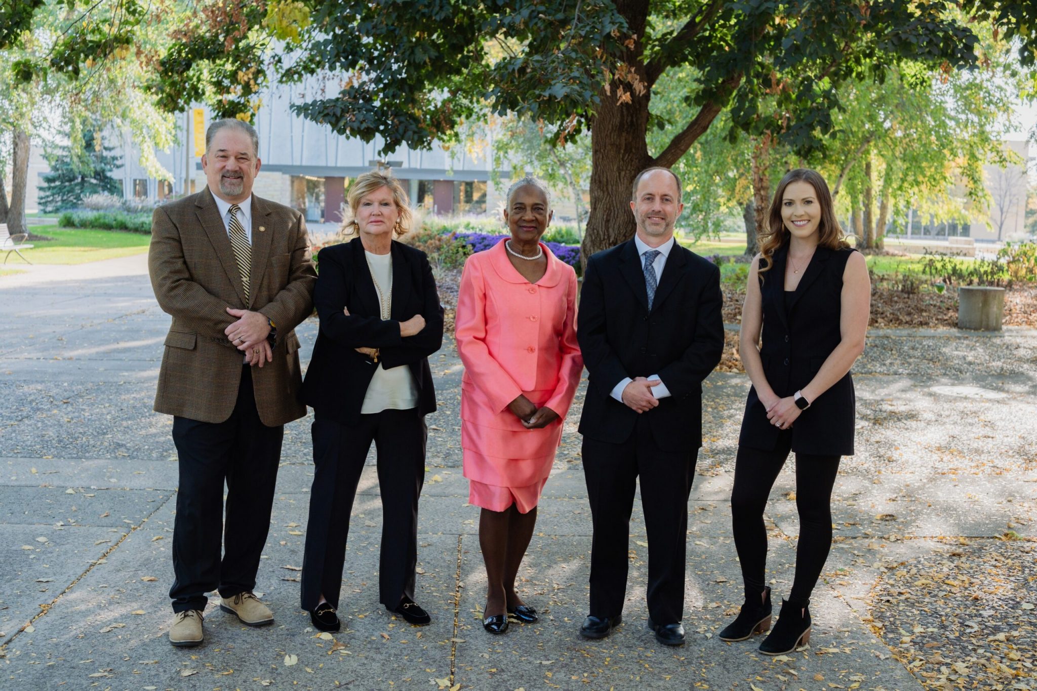 Group photo of five Alumni Award winners standing outside on a fall day