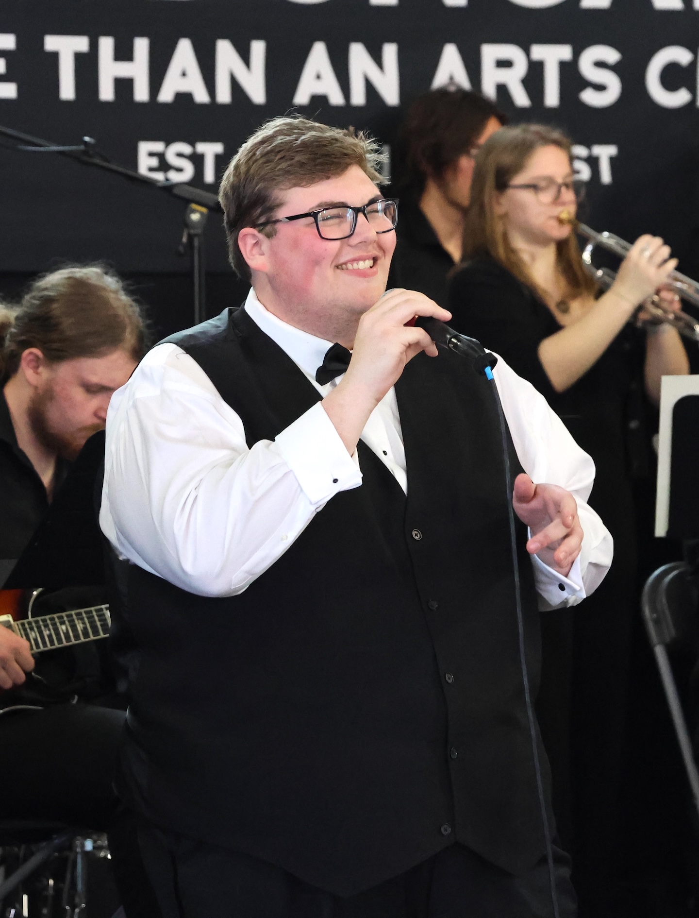 A man sings in a jazz band. 