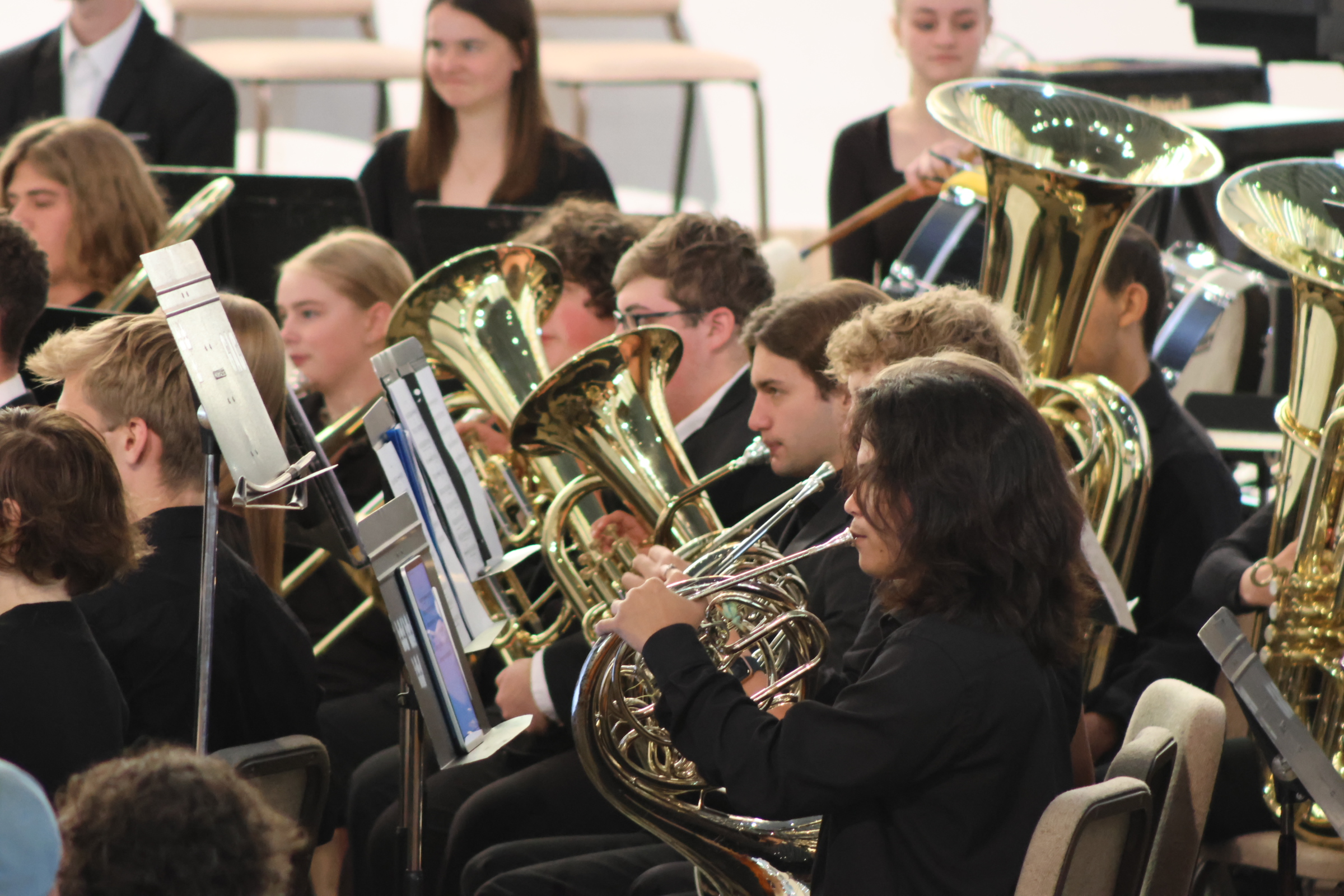 Students in the Gustavus Wind Symphony performing on brass and string instruments in Christ Chapel.