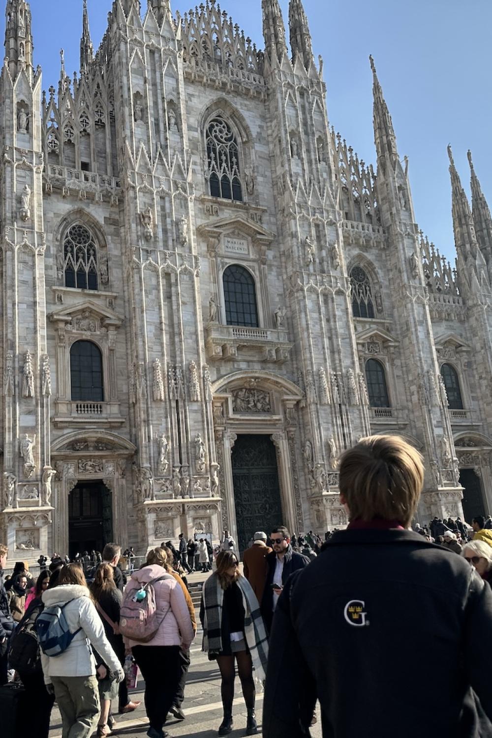 A student contemplates the largess of the Duomo in Milan. 