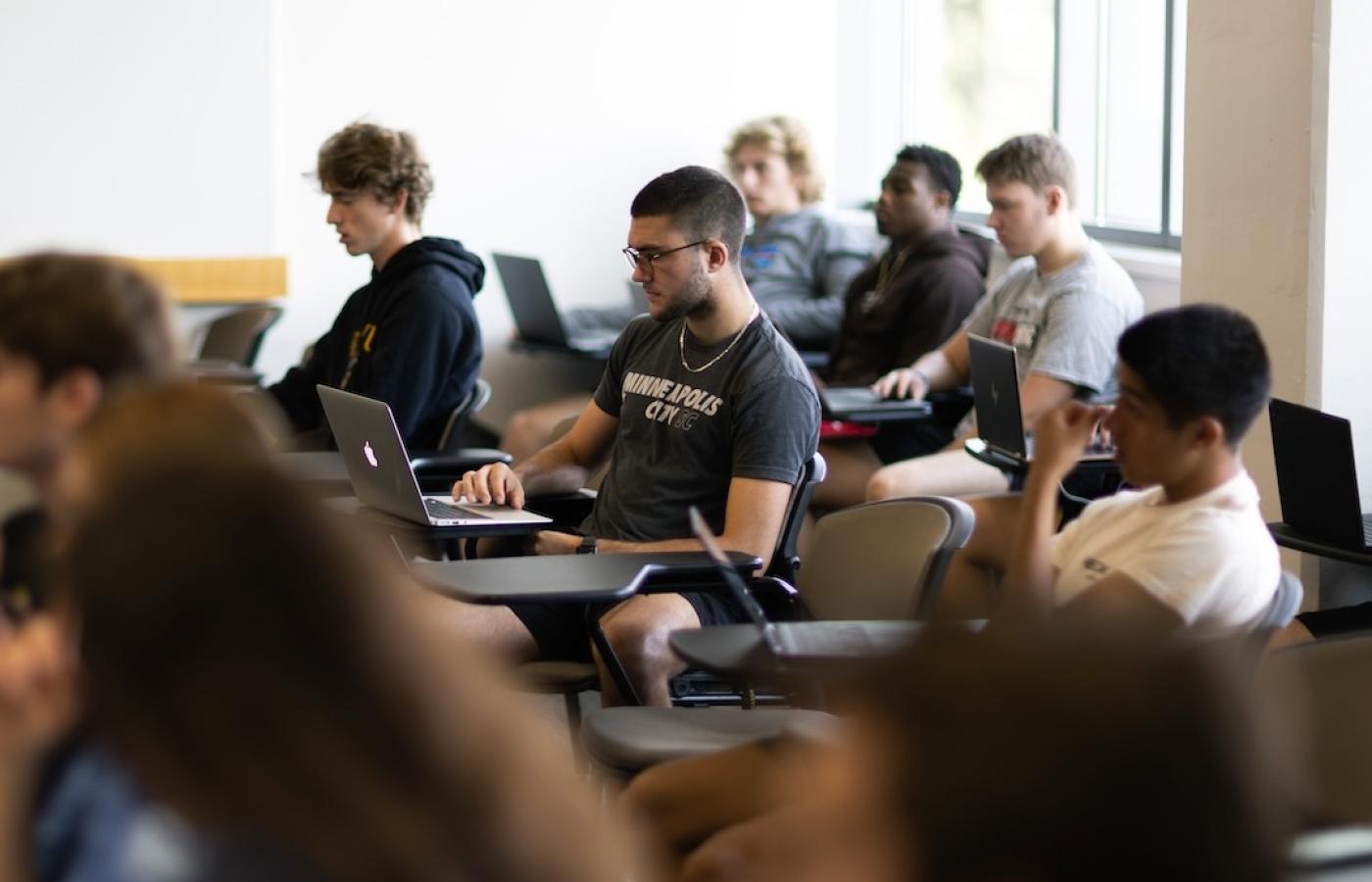 Students learning in a business classroom. 