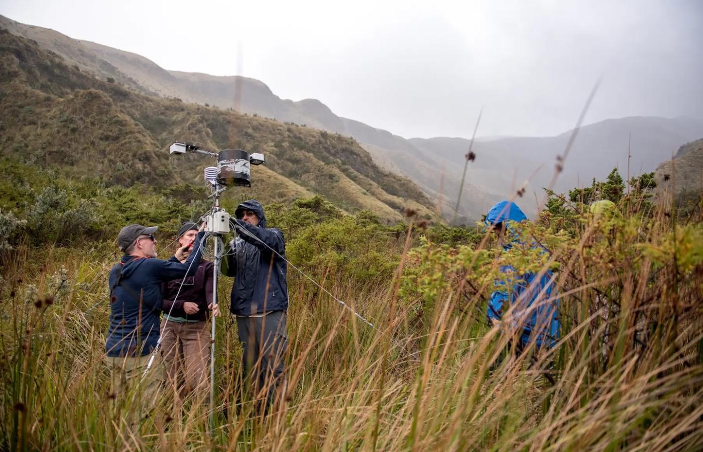 Students and professors work on weather recorders. 