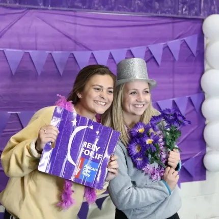 Two young women hold a Relay For Life sign
