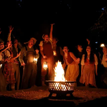 Excited people around a bonfire