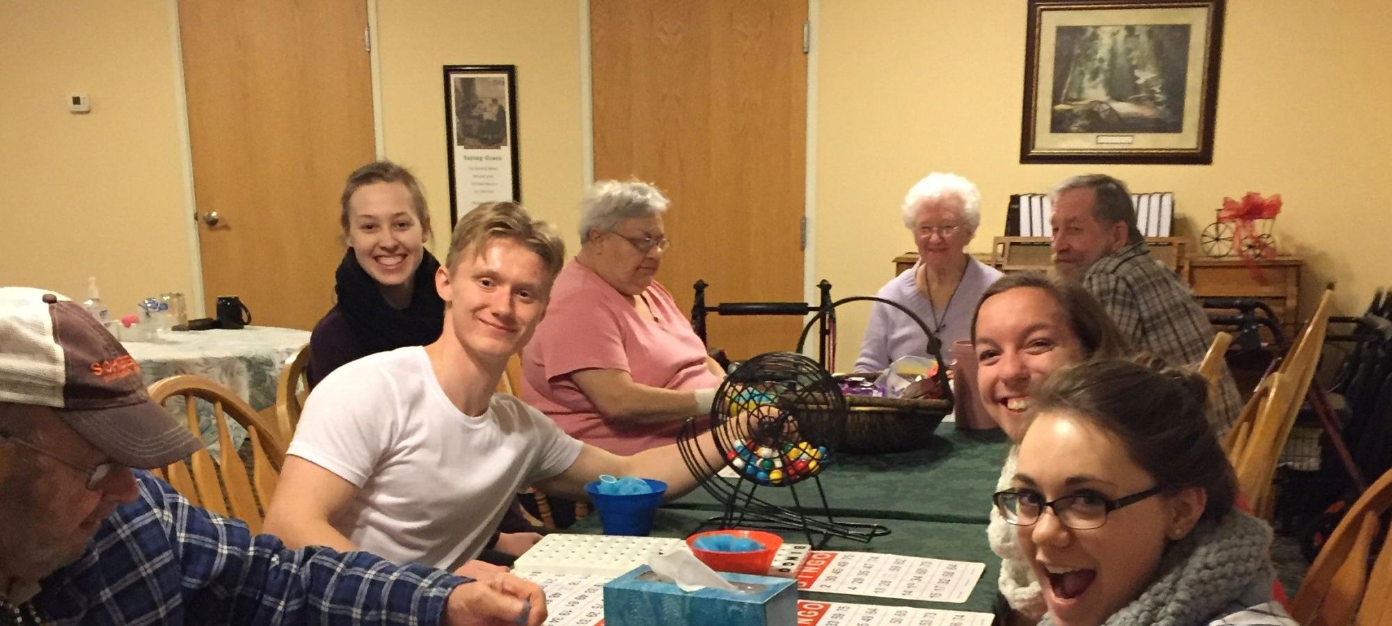 Students playing BINGO with residence in the Elders program