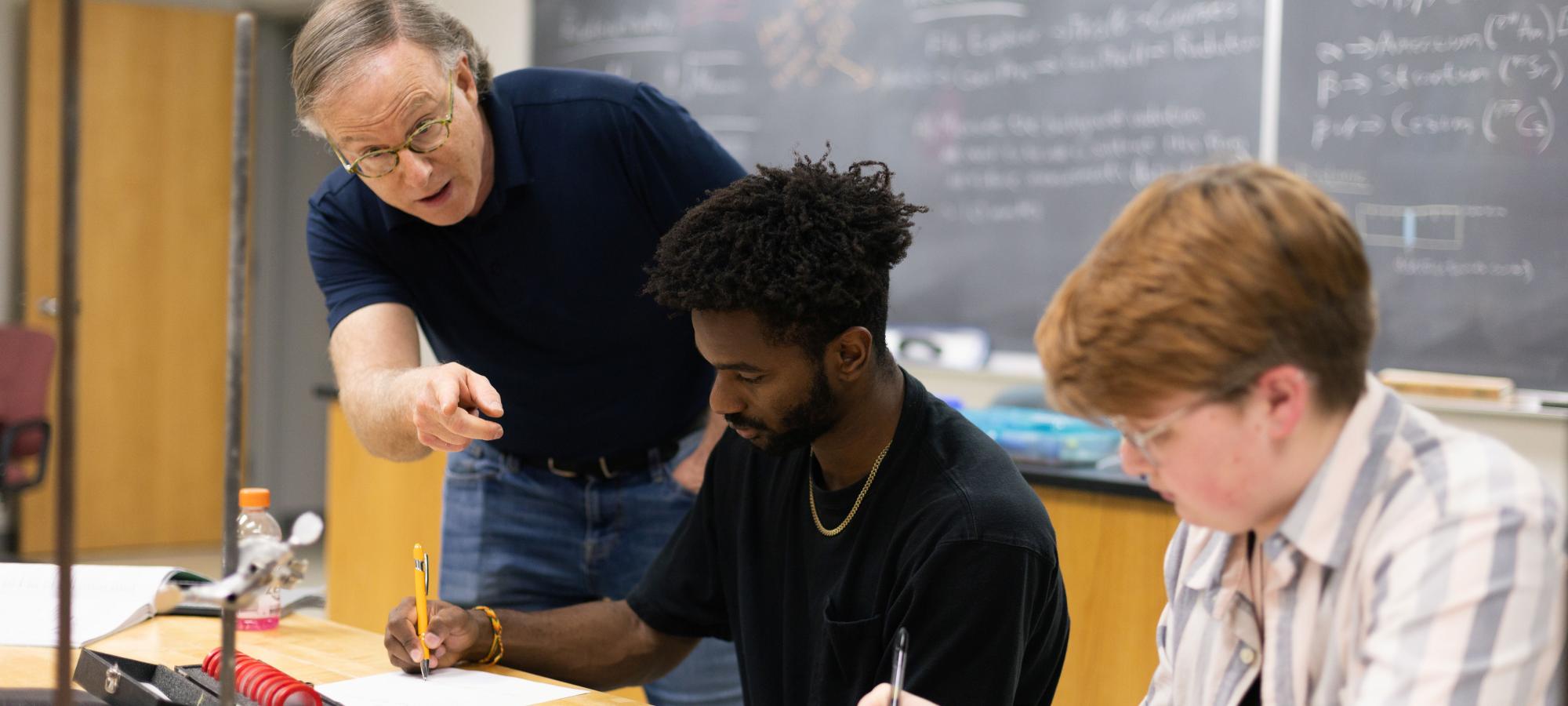 Physics students with faculty in lab