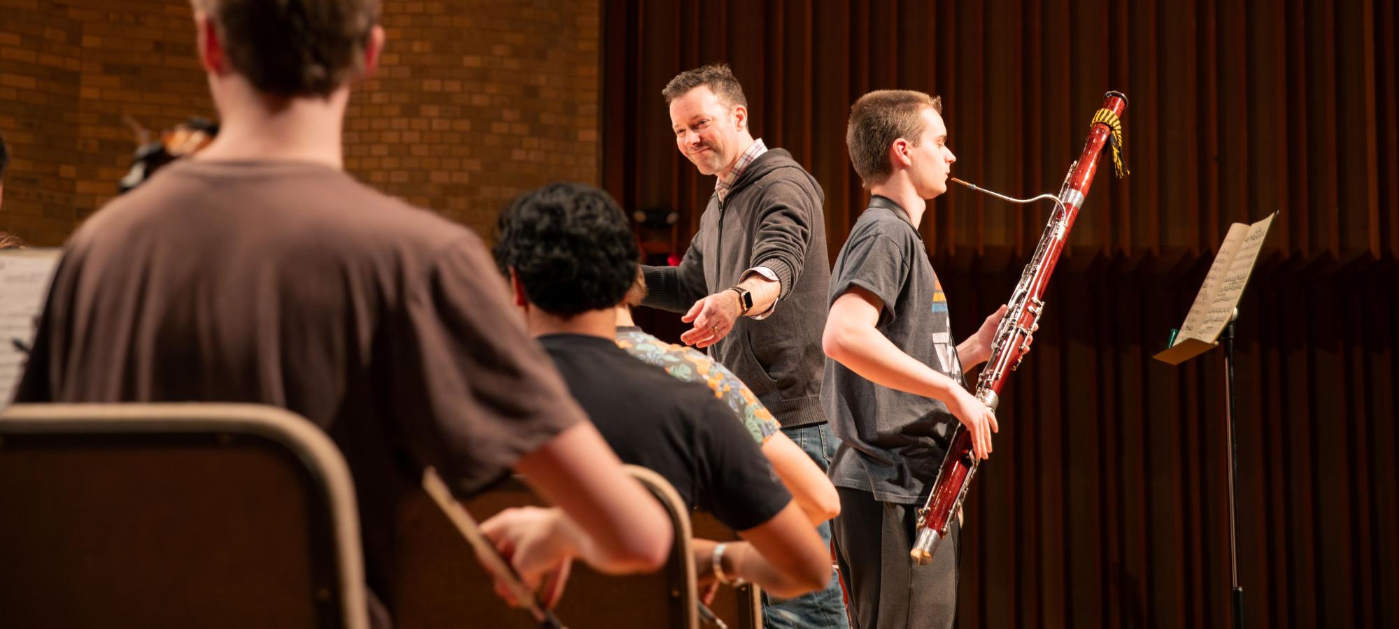 Faculty and students in string orchestra rehearsal