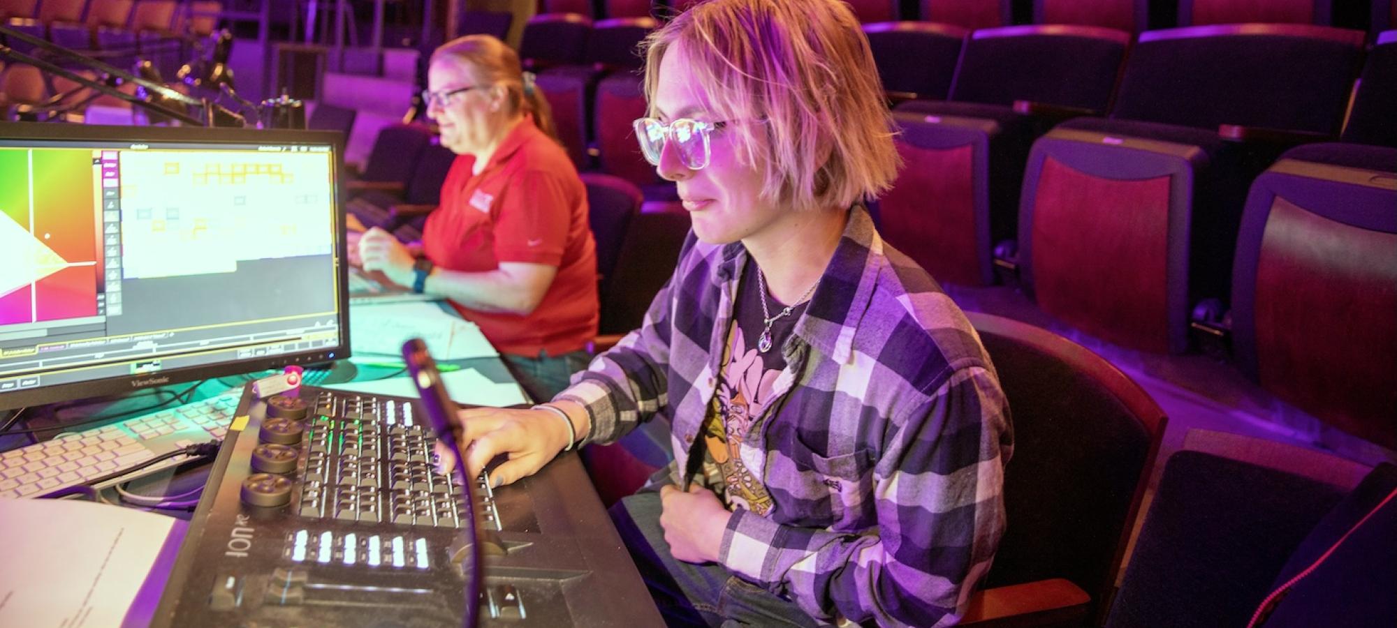 A Gustavus Adolphus College student works a theatre tech board. 