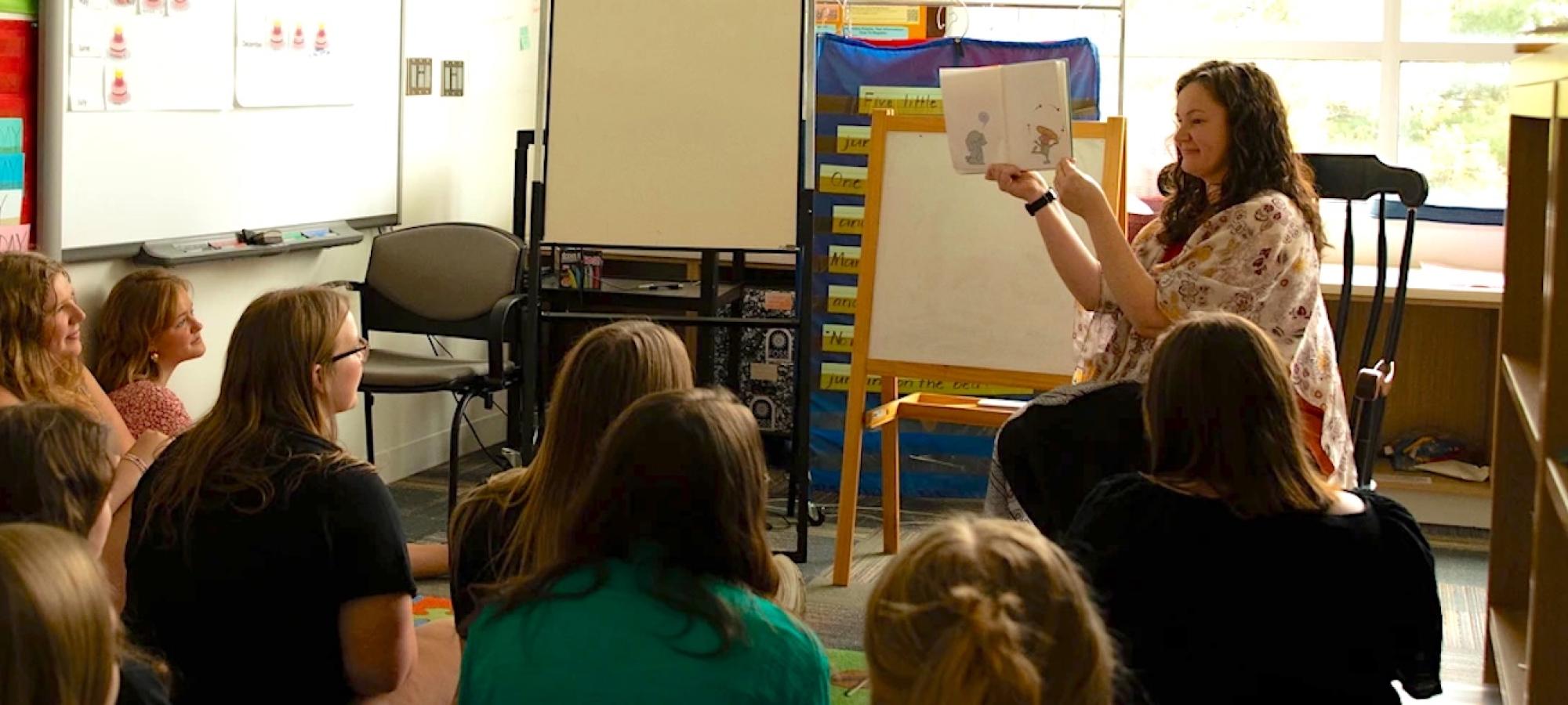 A Gustavus Adolphus College professor shows a book to a class. 