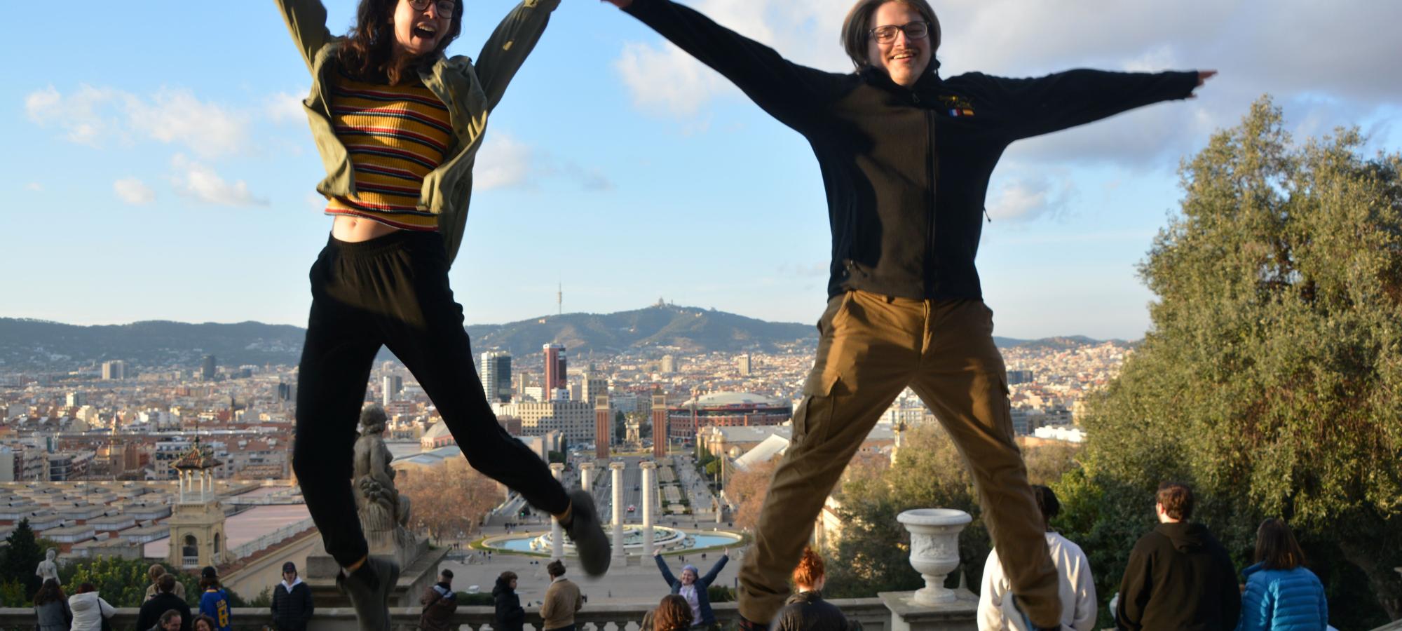 2 students jumping while on band tour