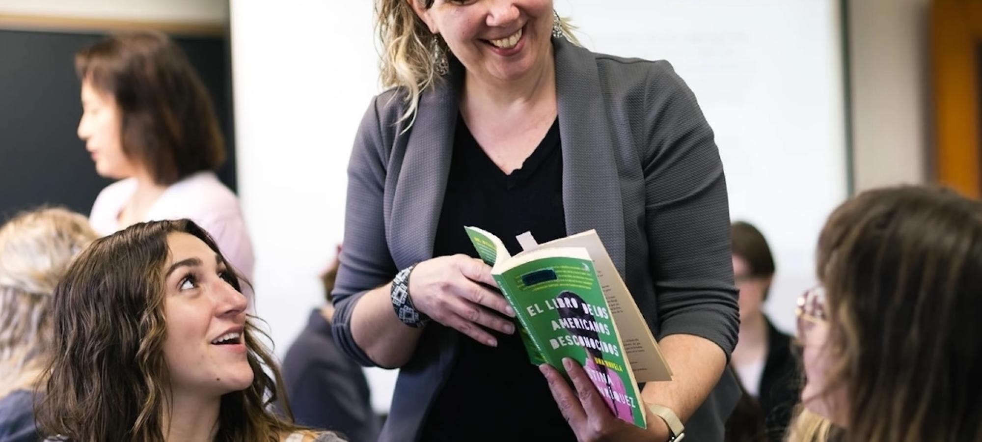 A professor shares a book with a student. 