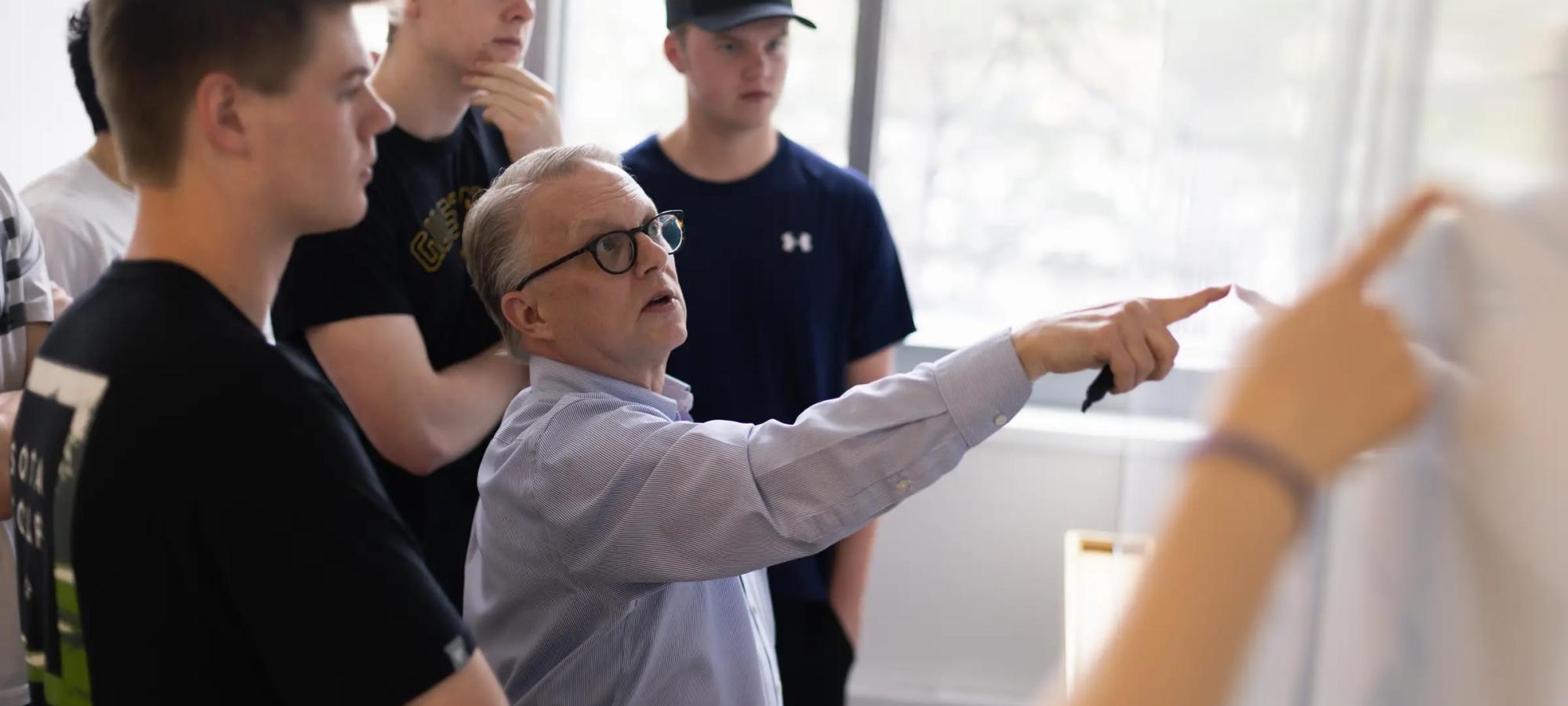 A professor demonstrates to students. 