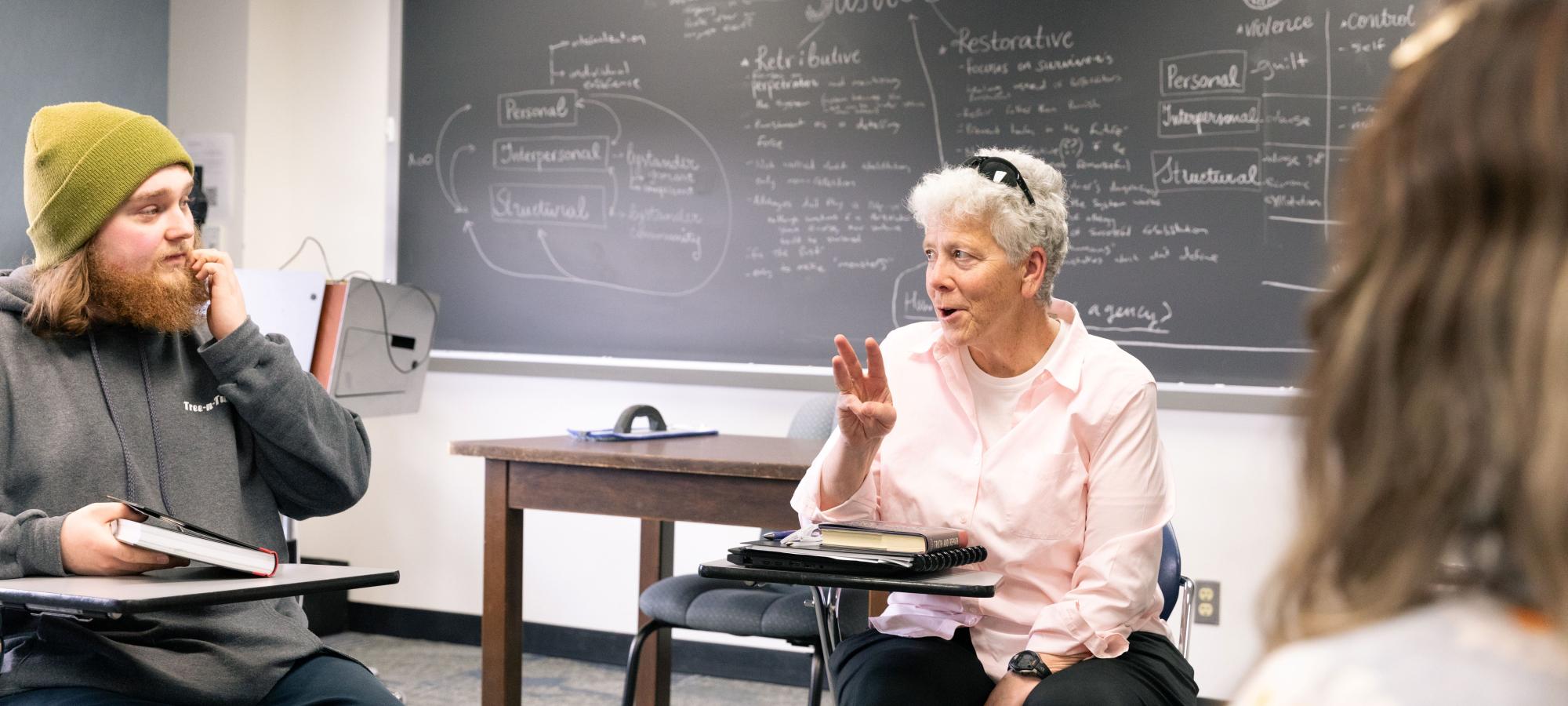 philosophy class with student and faculty