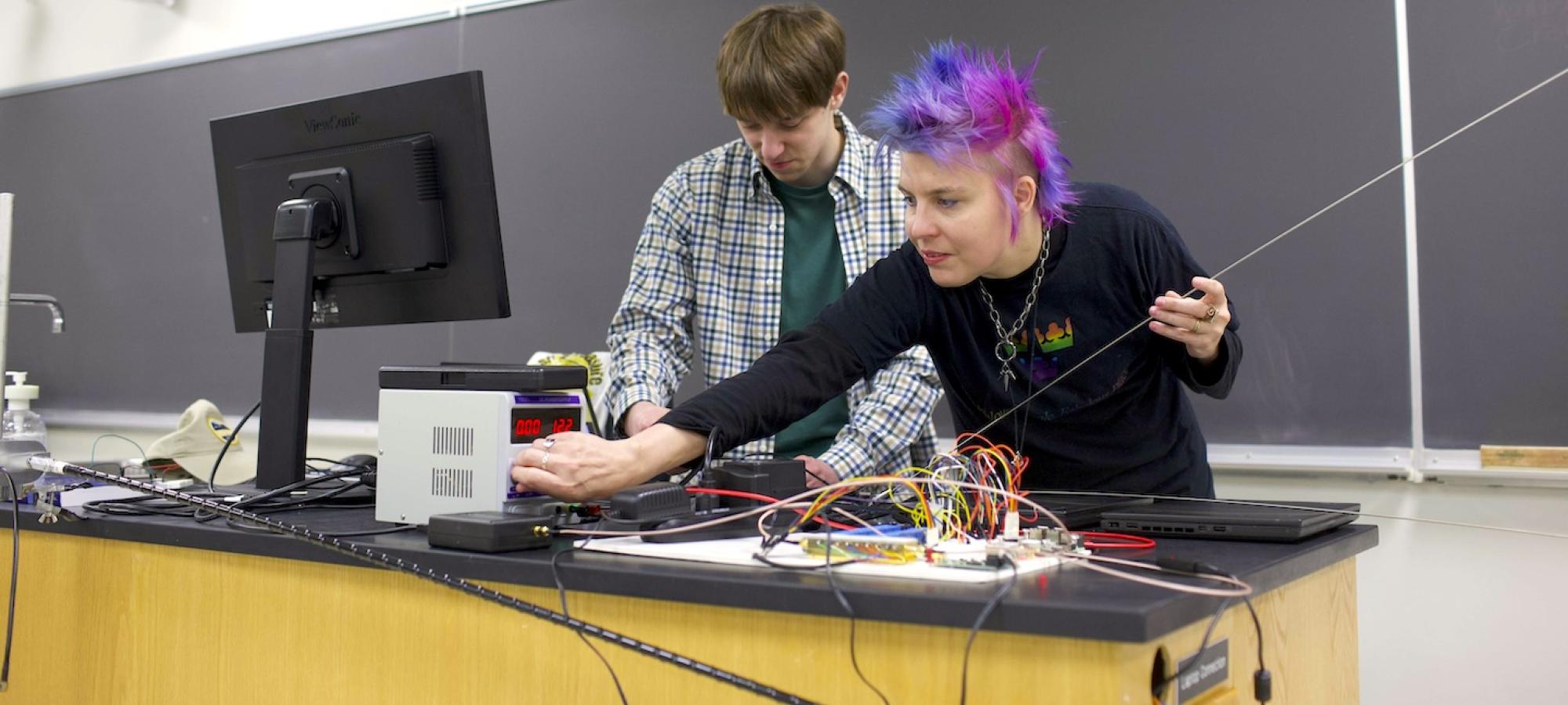 A Gustavus Adolphus College physics professor and student work with instrumentation. 