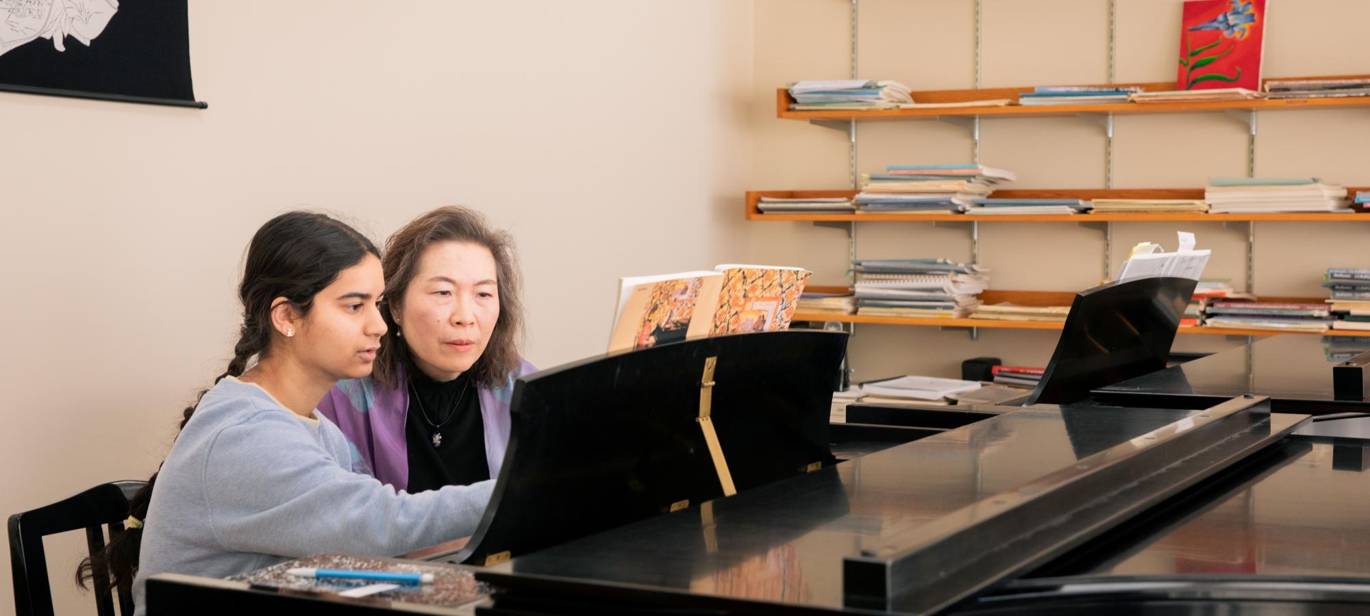 Faculty and student in piano lesson