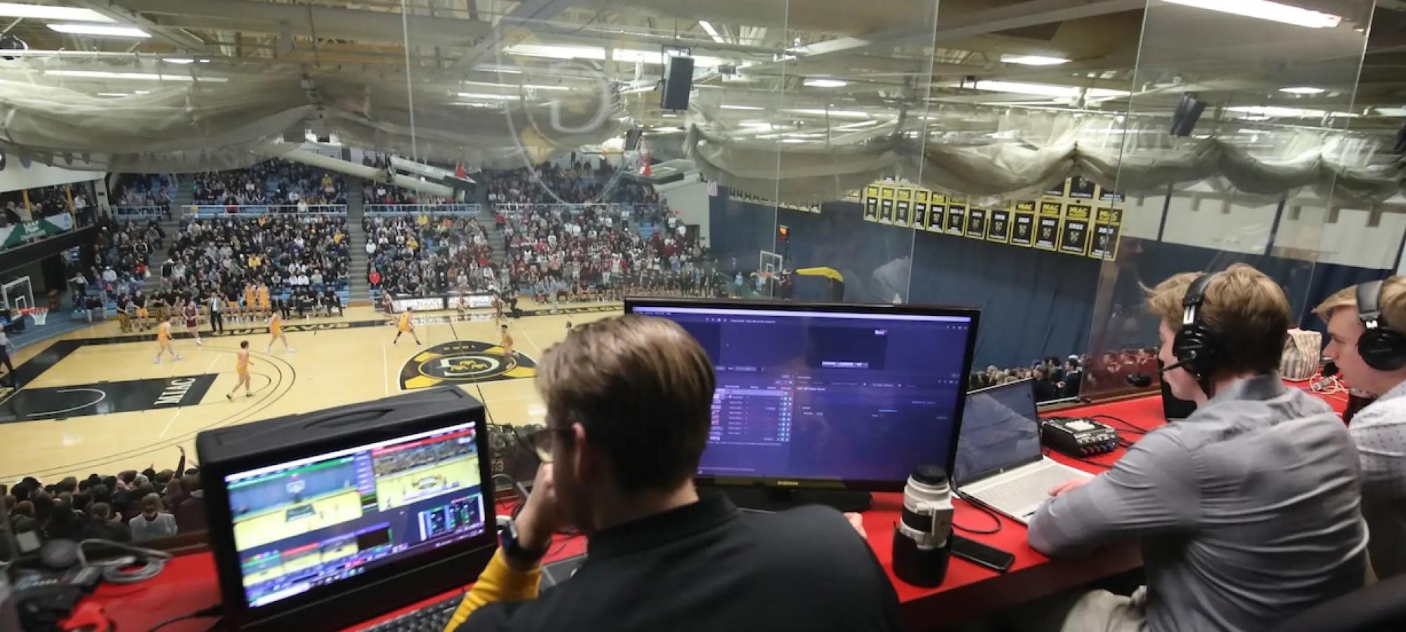 Gustavus Adolphus Students in the media booth during a basketball game. 