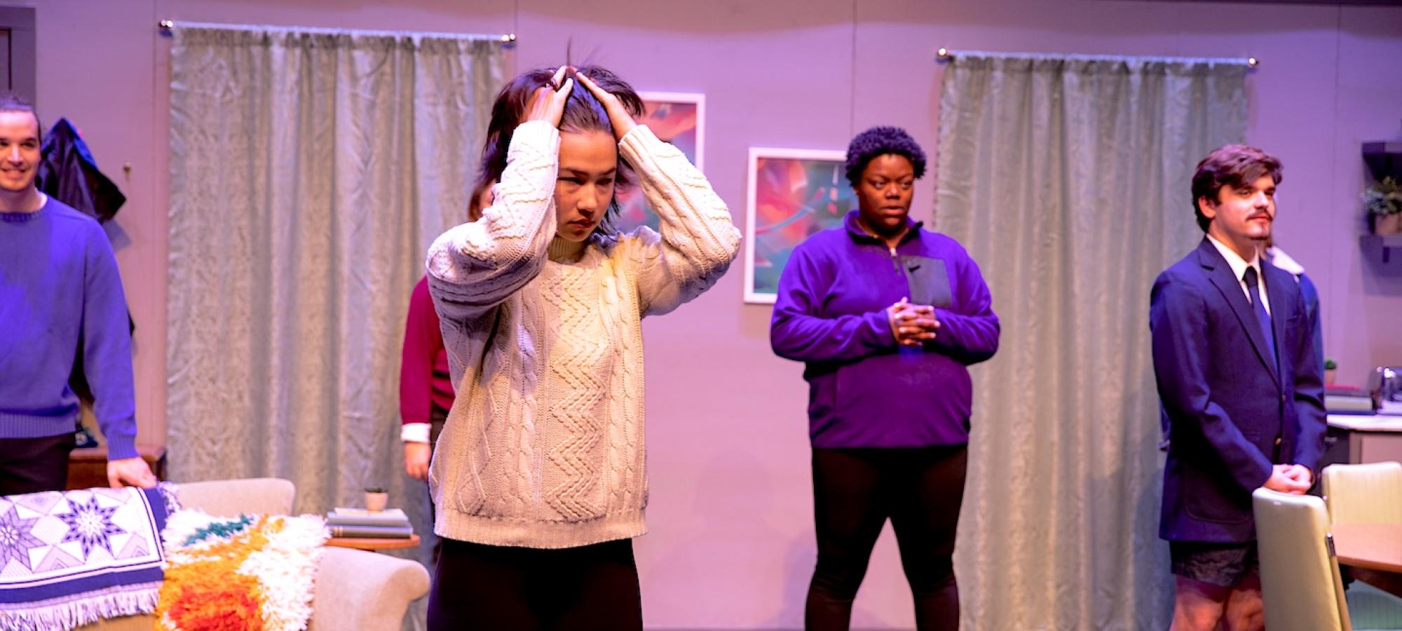 Theatre students question something offstage. 