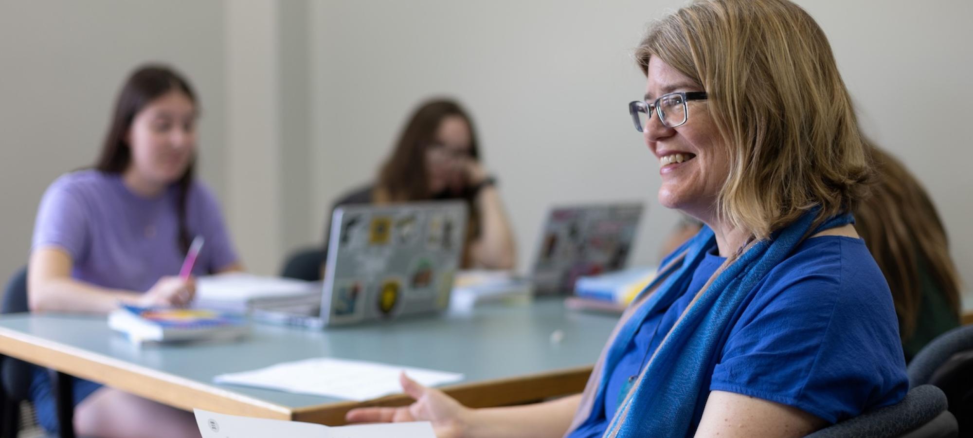 A Gustavus professor smiles at a student. 