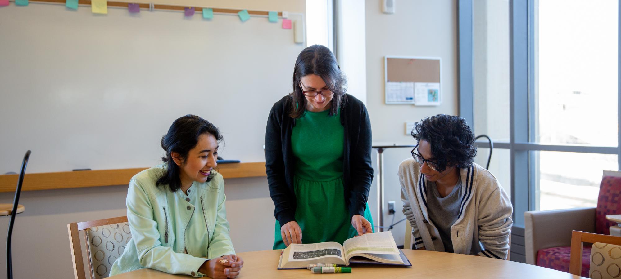 Faculty helping two students
