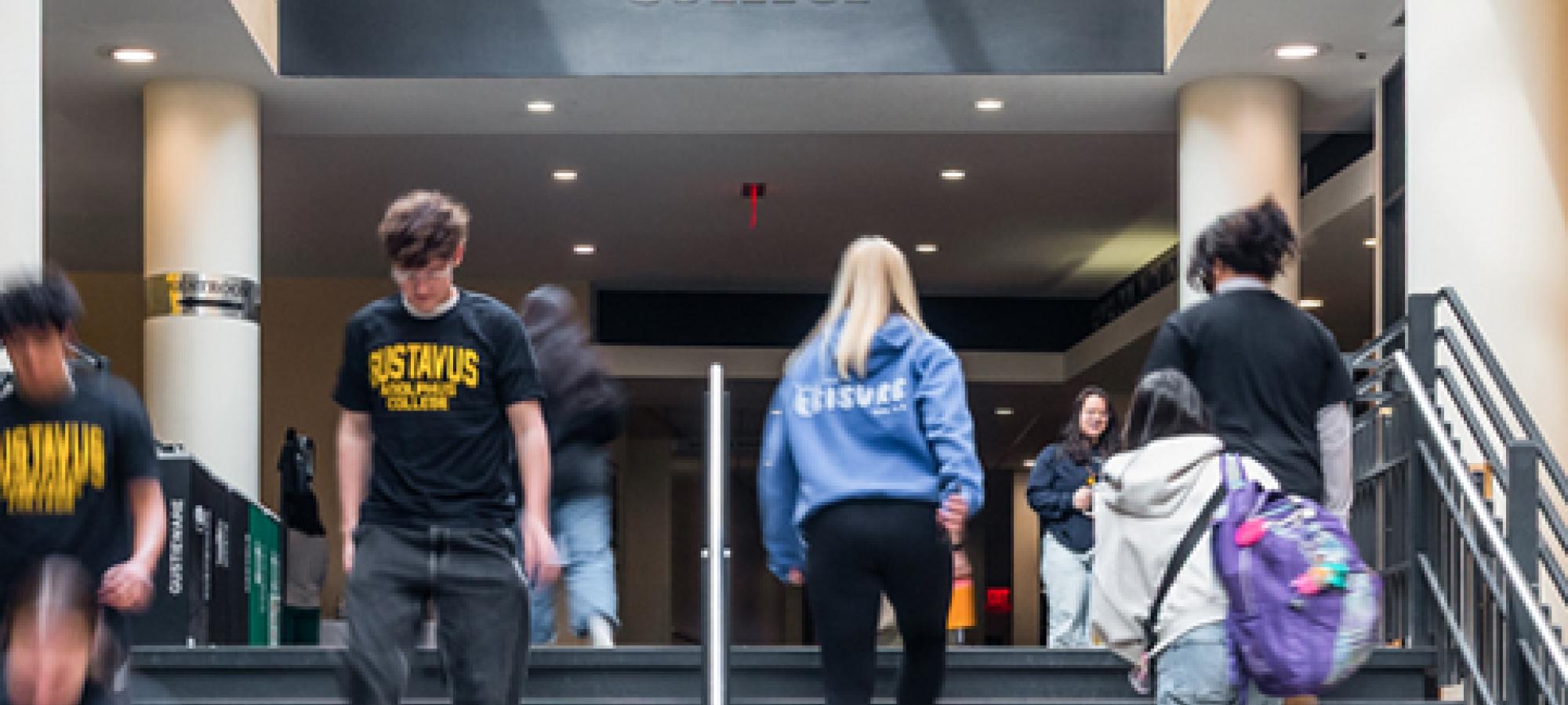 Visit campus students on campus center stairs