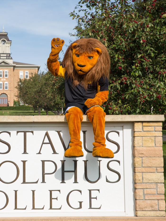 Gus the mascot at the college entrance