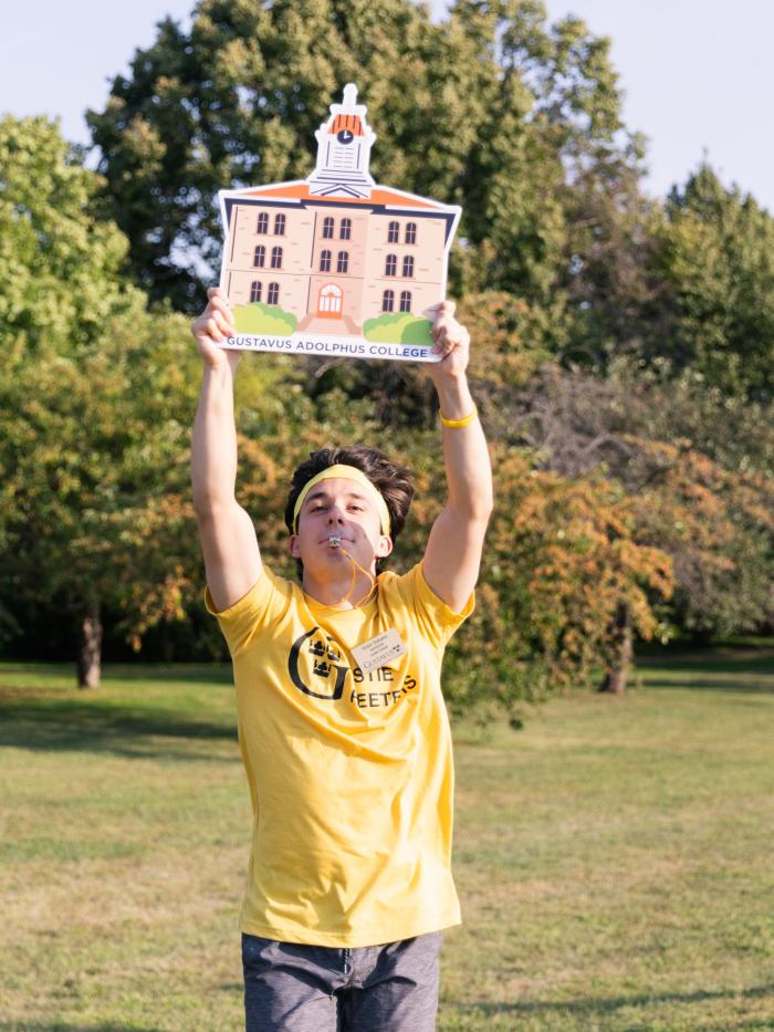 Greeter with Old Main sign
