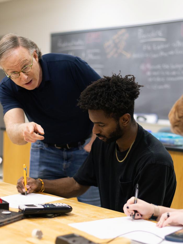 Physics students with faculty in lab