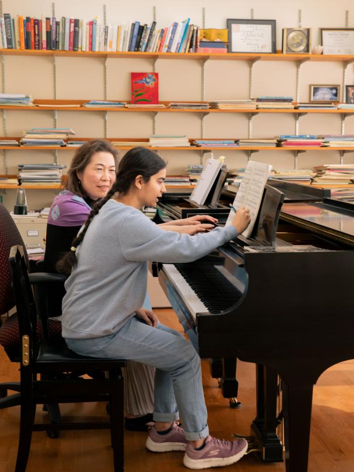 Faculty and student in piano lesson