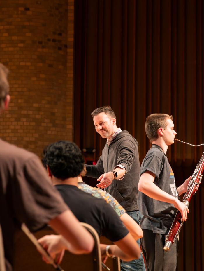 Faculty and students in string orchestra rehearsal