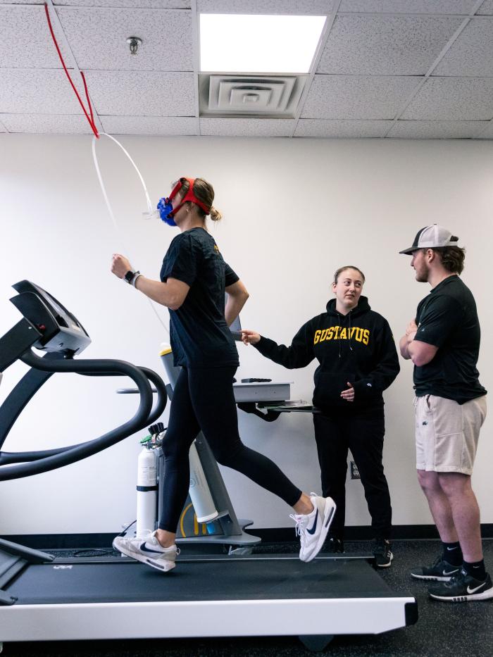 Athletic trainer with jogger on treadmill