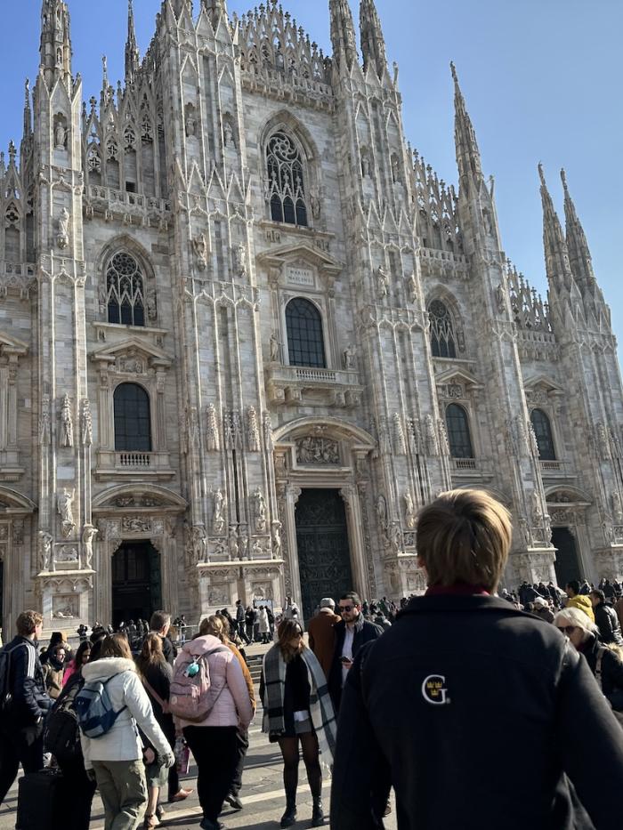 A student contemplates the largess of the Duomo in Milan. 