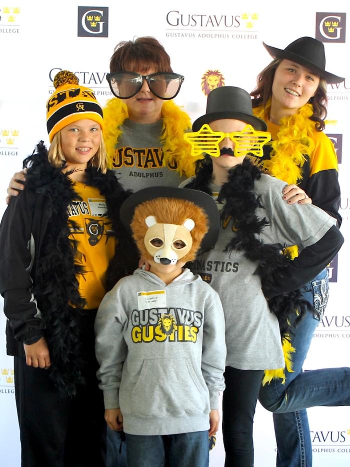 A family in college Homecoming costumes get their photo taken.