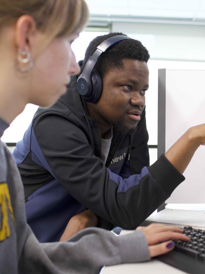 A student points something out to another student