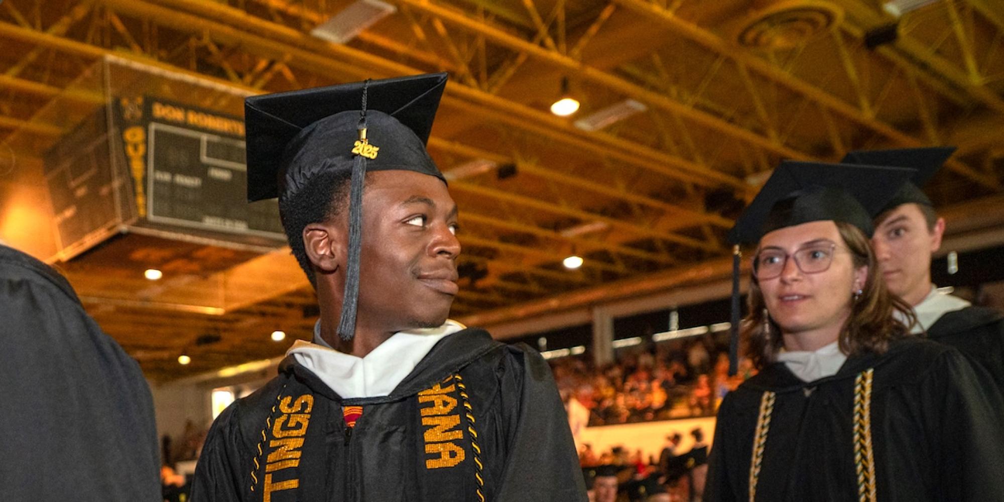 A graduate of Gustavus Adolphus College looks toward the future in his cap and gown. 