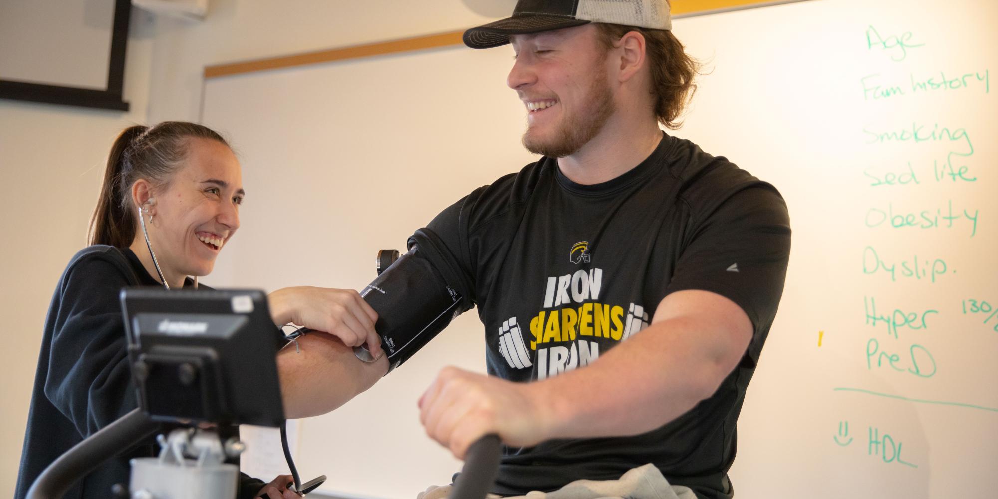 Athletic trainer with person on bike